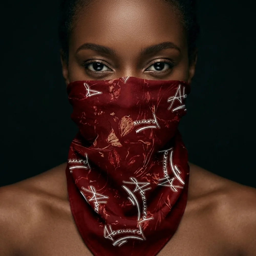 The scarf worn across the face in Oxblood.